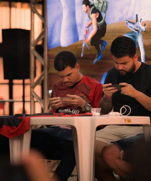 Group of gamers intensely focused during a mobile e-sports tournament indoors.