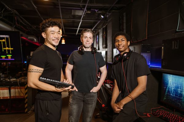 Diverse group of friends in an e-sports arena, showcasing teamwork and gaming excitement.